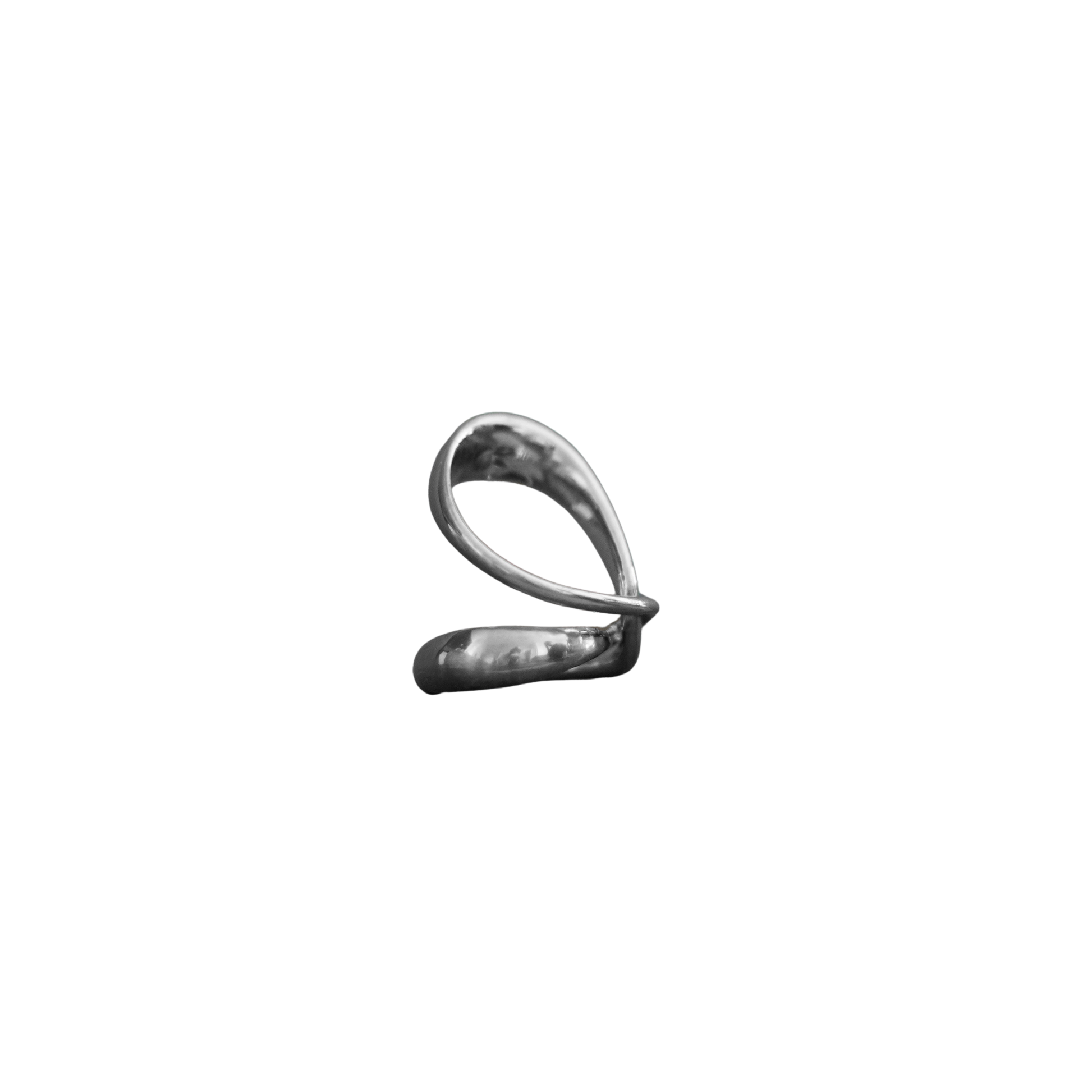A small metallic silver object with a looped, abstract shape, centered on a plain white background.