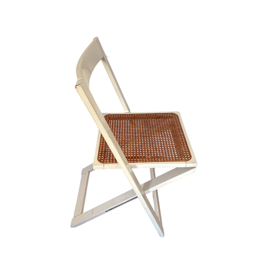 Chair with wicker seat and white frame on a white background